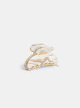 The Large Round Claw is a beige and cream marbled acetate hair clip with a curved, rounded top and interlocking teeth, handcrafted in France, shown against a plain white background.