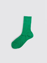 A single Maria La Rosa Bio Cotton Ribbed Sock in bright green is laid flat on a light gray background, highlighting the refined elegance of Italian artisan craftsmanship.