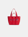 The Painted Perfect Daily Tote is a vibrant red cotton bag featuring two sturdy handles and the letters SOM in blue and white displayed on the front. This monogrammable tote is showcased against a clean, white background.