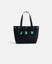 The Perfect Weekday Tote is a black cotton bag with two handles and bold green and white 