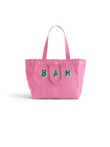 Introducing the Memorial Sloan Kettering Cancer Center × Alex Mill Perfect Weekday Tote—a personalized pink bag featuring two sturdy handles and bold green “BAM” lettering on the front. Set against a plain white background, this standout tote is perfect for supporting breast cancer research or expressing your unique style.