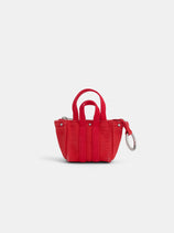 The Teeny Tiny Tote Keychain is a small red fabric tote with two handles, a zipper closure, and a silver keyring attachment, shown against a plain white background.