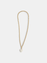 The Roxanne Assoulin Mini Puffy Heart Necklace features a gold brass cable chain with a small white puffy heart pendant, shown on a plain white background.